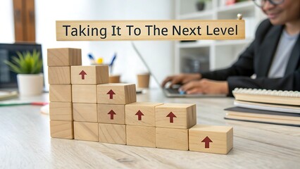 Next Level Growth Concept – Wooden Arrow Blocks with Business Laptop & Desk Setup 