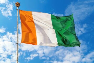 Waving Irish flag under a clear blue sky during a sunny day
