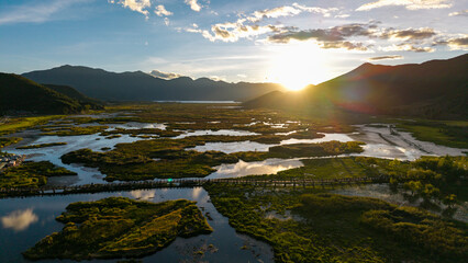 The grassland scenery and wooden boardwalk on Sunset Lake