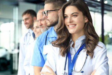 Female doctor with group of happy successful colleagues.