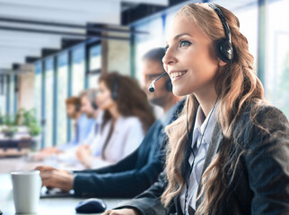 Portrait of call center worker accompanied by his team. Smiling customer support operator at work