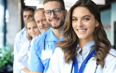 Female doctor with group of happy successful colleagues.