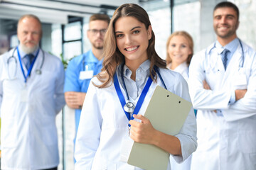 Female doctor with group of happy successful colleagues.