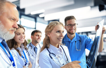 Group of doctors checking x-rays in a hospital.