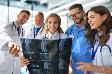 Group of doctors checking x-rays in a hospital.