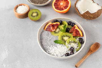Healthy breakfast bowl with chia pudding on coconut milk, kiwi, blood orange, and berries