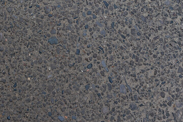 Detailed asphalt surface featuring small pebbles creates a versatile textured background for design projects