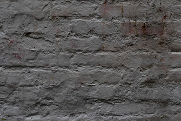 Rustic brick wall with weathered gray paint offers a versatile, textured backdrop for urban designs