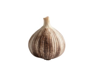 Single clove of garlic with striated pattern against a stark black background