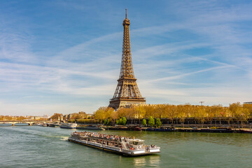 Fototapeta premium Eiffel Tower and cruise boat on Seine river in Paris, France