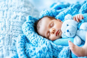 Newborn baby sleeps peacefully on cozy blue blanket with teddy bear in a serene indoor setting
