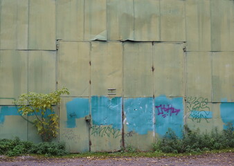 The old gates of a large sheeting-made hangar, Granite Street, Saint Petersburg, Russia, October 12, 2025