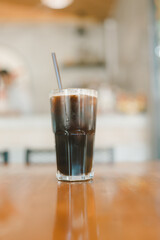 Iced black coffee americano served on wood table in cafe restaurant