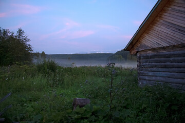 A village at sunset in the fog