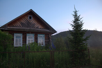 A village at sunset in the fog