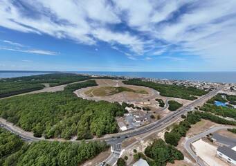Aerial View Of Circular Road Loop Surrounding Hilltop Wright Brothers Monument With Outer Banks Coastline In Distance