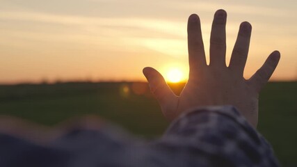 man hand shades towards the sunset, man prays bowing to sunset, traveler dreamer, glare of light through his fingers, day off nature, meeting the morning dawn, believing in goodness, hand protection.