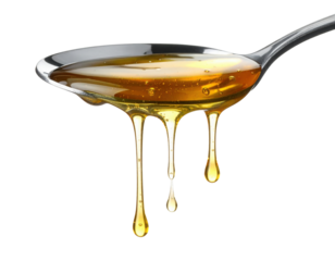 A close-up of honey dripping from a metal spoon, showcasing its texture and color.