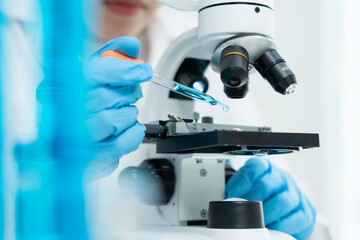 Scientist analyze biochemical samples in advanced scientific laboratory. Medical professional use...
