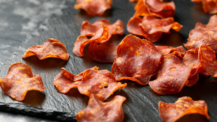 Spanish chorizo crisps in a stone board. A high protein snack.
