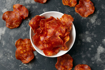 Spanish Chorizo Crisps in a white bowl. A high protein snack.