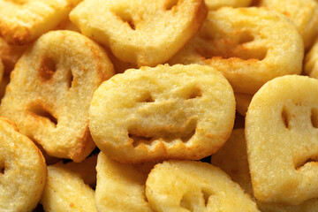 Fried Halloween potato shapes on black plate.