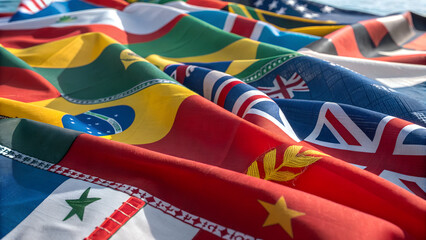 Colorful collection of international flags representing global unity, diplomacy, diversity and international cooperation across nations in bright daylight