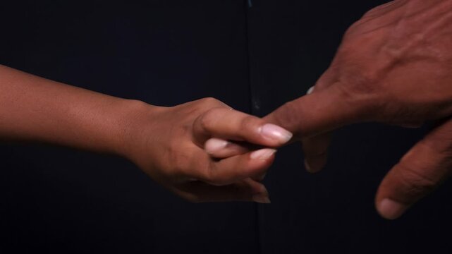 Male and female hands hand gesture on black isolated background. Imitates sex. A vulgar and exciting hand sign. Indecent hand gestures that show how sex happens. imitation penis and vagina.