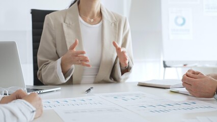 Business people team discussing financial data and analyzing charts during a productive meeting in the office, focusing on collaborative teamwork and strategic decision making