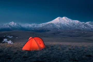 Fotobehang Nachtblauw Night landscape with red bright tent mountain ridge snow-covered Mount Elbrus, Caucasus, Russia  © Igor