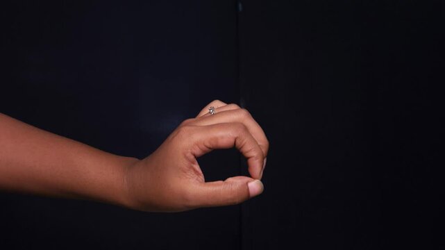 Male and female hands hand gesture on black isolated background. Imitates sex. A vulgar and exciting hand sign. Indecent hand gestures that show how sex happens. imitation penis and vagina.