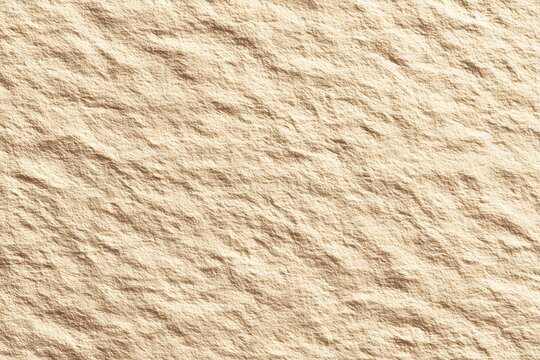A close up of a beige textured surface with subtle variations and rough unevenness throughout image