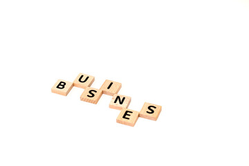Business Concept Depicted with Wooden Letter Tiles Arranged on White Surface