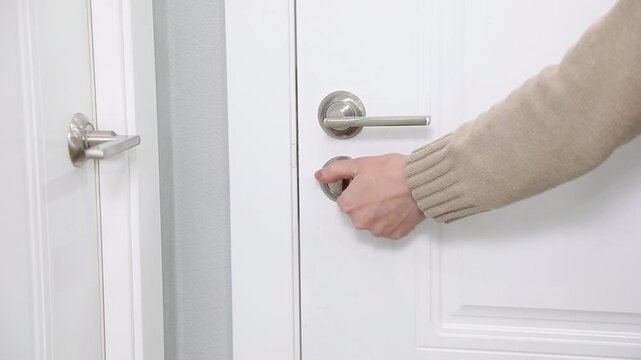 sharp clicking of a bedroom door's twist lock