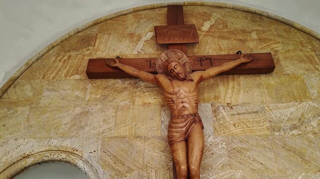 Crucifix of Jesus Christ on wall of church.
