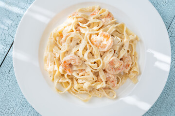 Creamy fettuccine shrimp pasta white plate savory sauce gourmet flavor