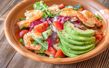 Fresh prawn avocado salad cherry tomatoes wooden table citrus dressing