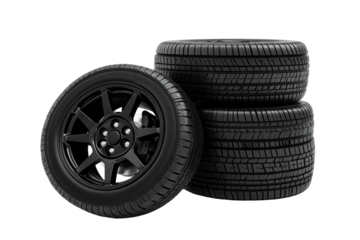 Stacked tires with rims, one tilted to show details, on a black backdrop