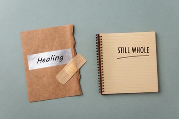 Notebook and torn paper with bandage showing healing and wholeness