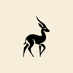 Obraz premium Black gazelle silhouette with curved horns on beige background