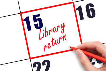 15 th day of the month.  Hand writing Library return reminder and drawing red frame on calendar with red pen on white background. Reading concept. Planning and scheduling