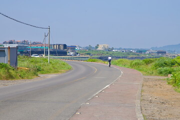 Cyclist on Jeju Coastal Road