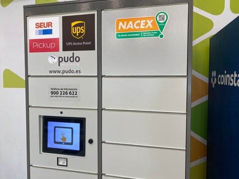 Palma, Spain - October 06, 2025: Pudo parcel locker with multiple delivery service logos, showcasing modern technology for convenient package pickup in urban environment