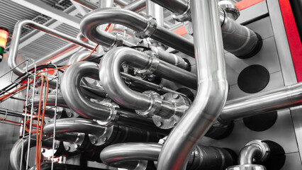 Bottom up view of industrial machine pipes in factory, industrial concept background