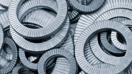 Metal fasteners round washers as a textured industrial background for web banner template page design in blue tone