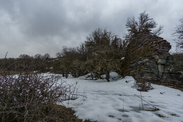 Rocky and snowy Winter landscape near Oxya Viewpoint at Vikos Gorge in Zagoria region at Pindus Mountains, Epirus, Greece