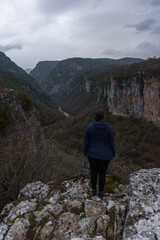View of the impressive Vikos gorge in the Zagoria region at Pindus Mountains on a dark winter day with atmospheric mood, Epirus, Greece
