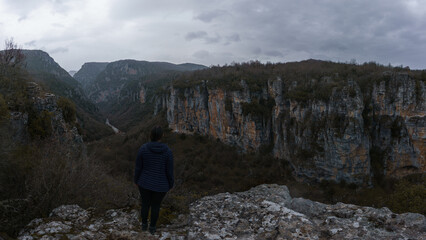 Panoramic view of the impressive Vikos gorge in the Zagoria region at Pindus Mountains on a dark winter day with atmospheric mood, Epirus, Greece