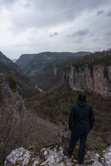 View of the impressive Vikos gorge in the Zagoria region at Pindus Mountains on a dark winter day with atmospheric mood, Epirus, Greece