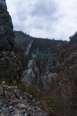 Rocky landscape of the Voidomatis Potamos valley in the Zagoria region at Pindus Mountains on a dark winter day with atmospheric mood, Epirus, Greece